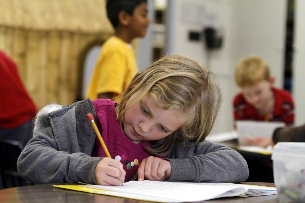 First grader Charlotte Williams, 6, works on a writing composition during class at Liberty Elementary School on Thursday, June 2, 2011, in Petaluma. (BETH SCHLANKER/ The Press Democrat)