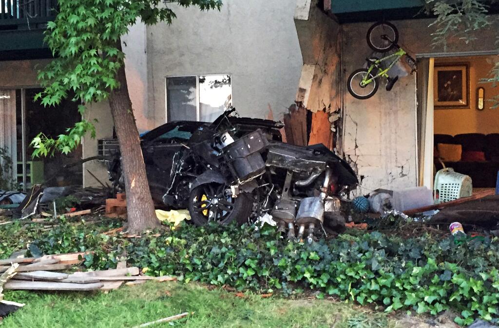 This Saturday, May 2, 2015, photo provided by the Livemore Police Department shows the scene after a car crashed into an apartment complex, killing a woman and toddler and slightly injuring two other children, in Livermore in Northern California. Police arrested Brian Jones, of Livermore on suspicion of gross vehicular manslaughter while intoxicated and another alcohol-related driving count, Officer Ryan Sanchez said. (Ryan Sanchez/Livermore Police Department via AP)