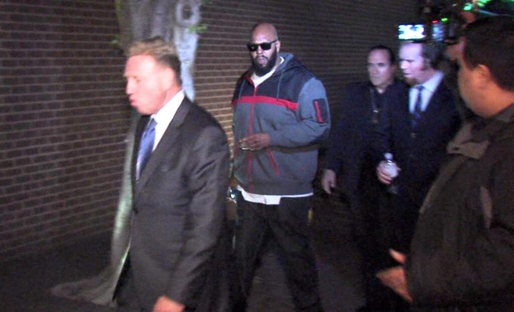 This image from video shows Death Row Records founder Marion 'Suge' Knight, right, walking into the Los Angeles County Sheriff's Department early Friday morning Jan. 30, 2015 in connection with a hit-and-run incident that left one man dead and another injured. (AP Photo/OnSceneVideo via AP Television)