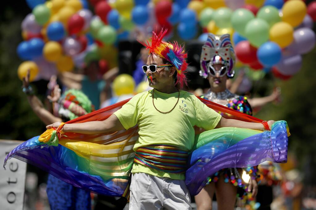 Luis Lowenberg dances during the Sonoma County Pride Parade in Guerneville, on Sunday, June 7, 2015. (BETH SCHLANKER/ The Press Democrat)