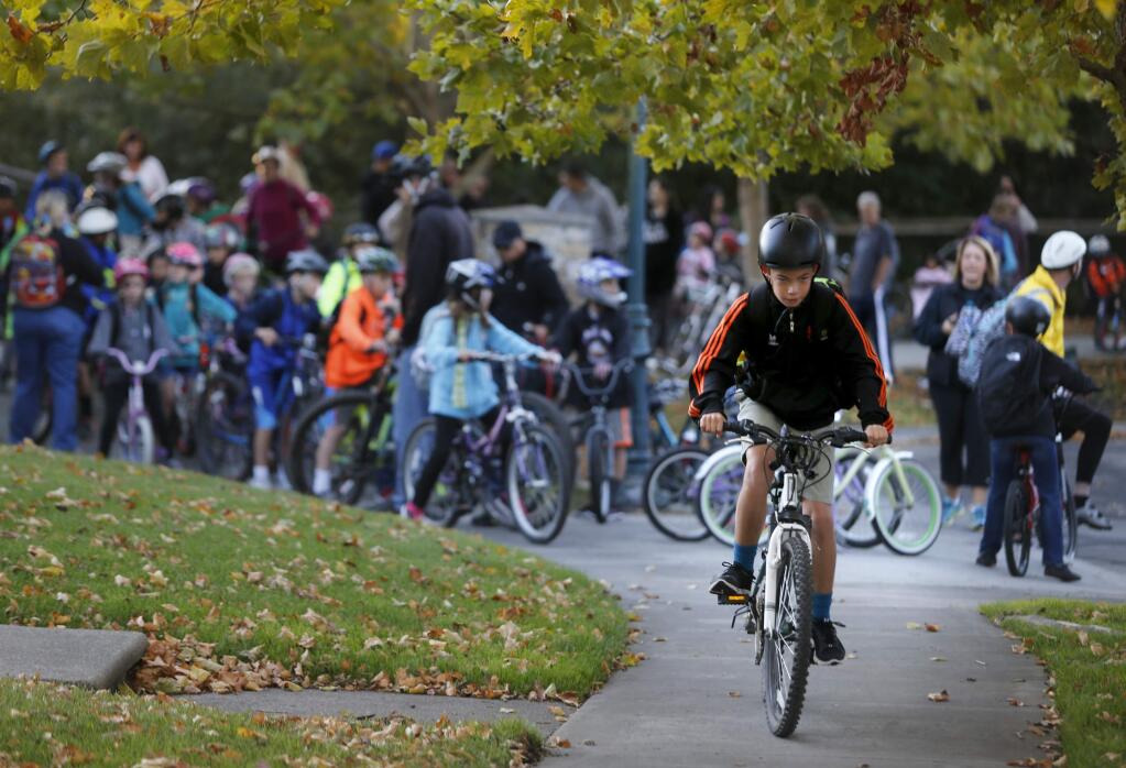 Dominic Dadalt, 12, rides in front of a bike train of Sonoma Mountain Elementary School students for Walk and Roll to School Day on Wednesday, October 5, 2016 in Petaluma, California . (BETH SCHLANKER/ The Press Democrat)