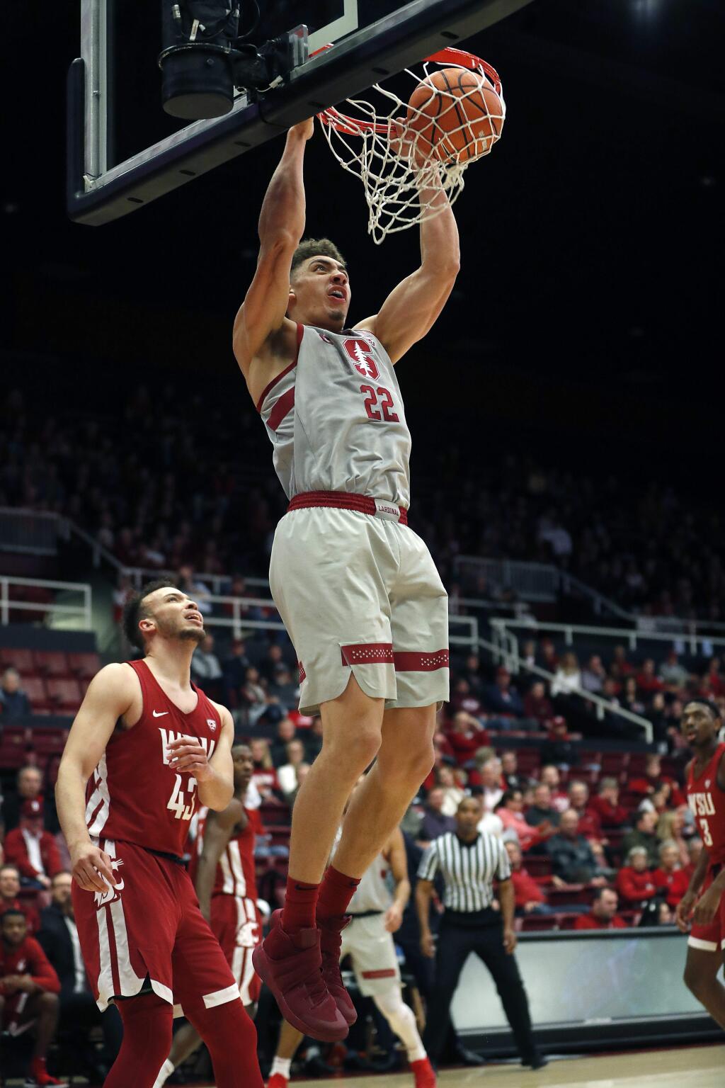 Stanford forward Reid Travis (22) dunks against Washington State during the first half of an NCAA college basketball game Saturday, Feb. 24, 2018, in Stanford, Calif. (AP Photo/Tony Avelar)