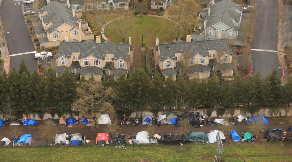 The homeless encampment along Joe Rodota Trail fronts the Casa del Sol townhouse complex, Tuesday, Jan. 14, 2020 in Santa Rosa. (Kent Porter / The Press Democrat) 2020