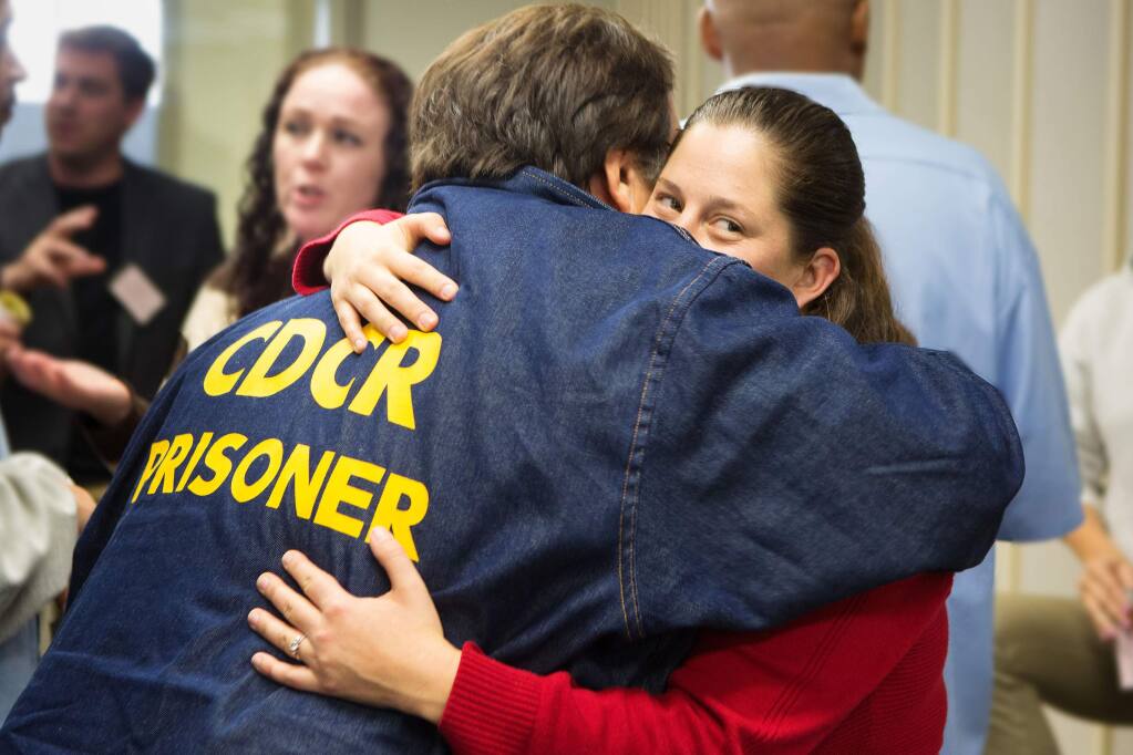 After giving a presentation at Solano State Prison in Vacaville, Jessica Stillman hugs her father, Fred Stillman, who was serving his 23rd year in the California for second-degree murder. He was paroled in August 2018. (CHARLIE GESELL)
