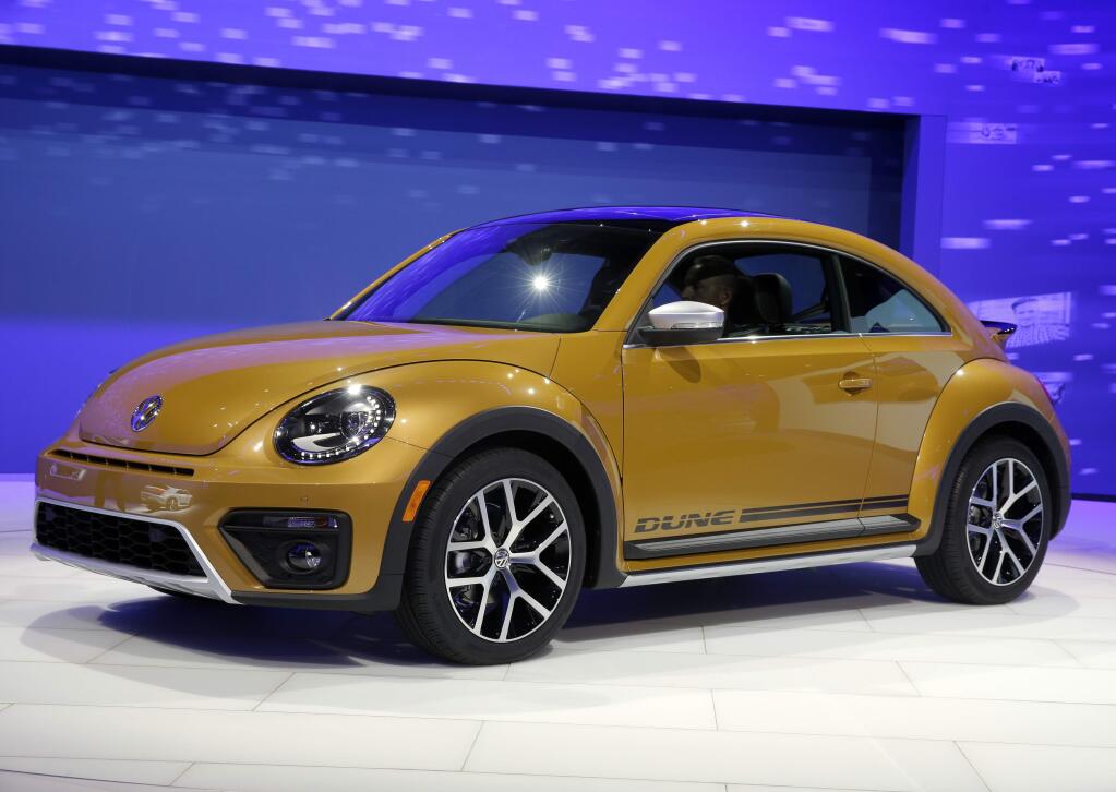 FILE- In this Nov. 18, 2015, file photo the 2017 Volkswagen Beetle Dune is displayed at the Los Angeles Auto Show in Los Angeles. Volkswagen says it will stop making its iconic Beetle in July of next year. Volkswagen of America on Thursday, Sept. 13, 2018, announced the end of production of the third-generation Beetle by introducing two final special editions. (AP Photo/Chris Carlson, File)
