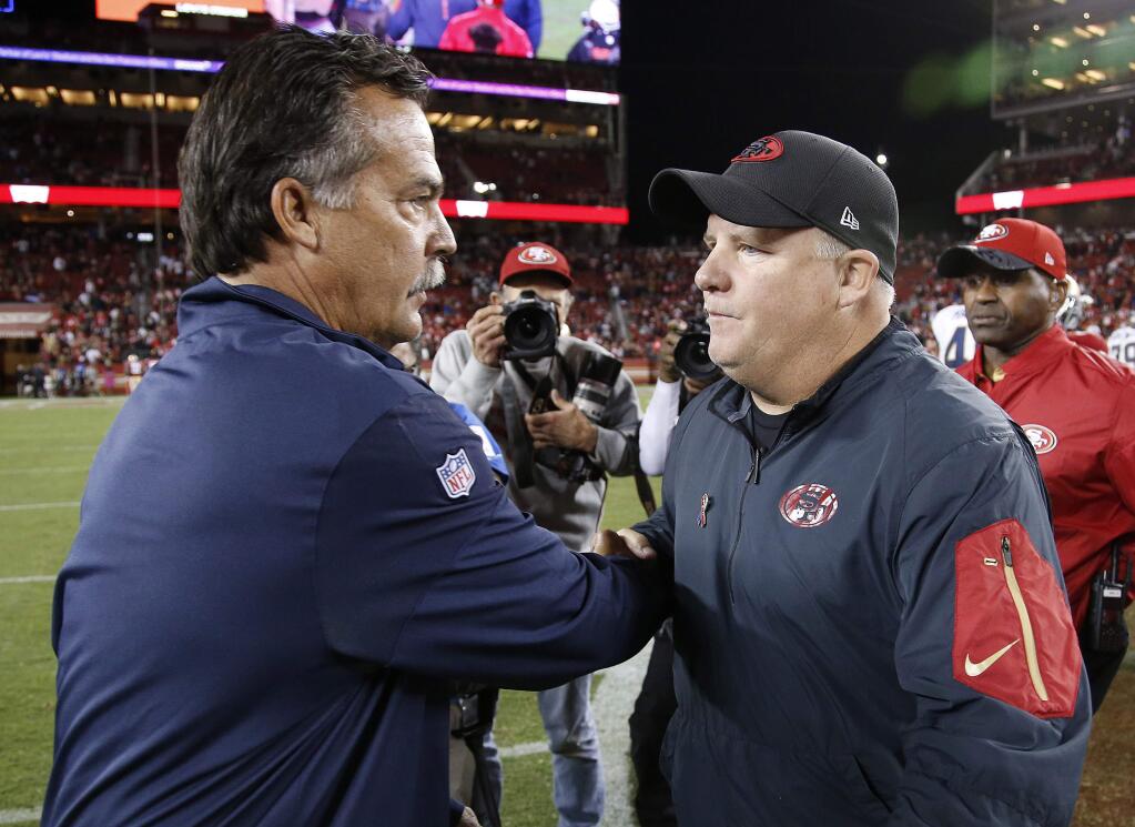 Los Angeles Rams head coach Jeff Fisher, left, shakes hands with San Francisco 49ers head coach Chip Kelly after an NFL football game in Santa Clara, Calif., Monday, Sept. 12, 2016. The 49ers won 28-0. (AP Photo/Tony Avelar)