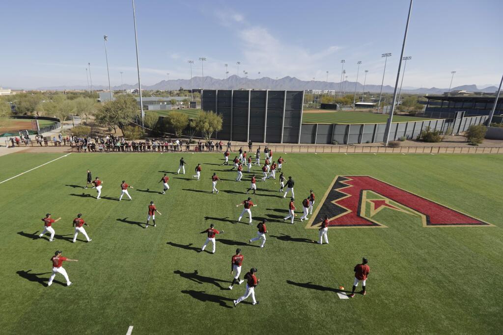 Arizona Diamondbacks pitchers stretch during spring training baseball practice, Sunday, Feb. 16, 2020, in Scottsdale, Ariz. (AP Photo/Darron Cummings)