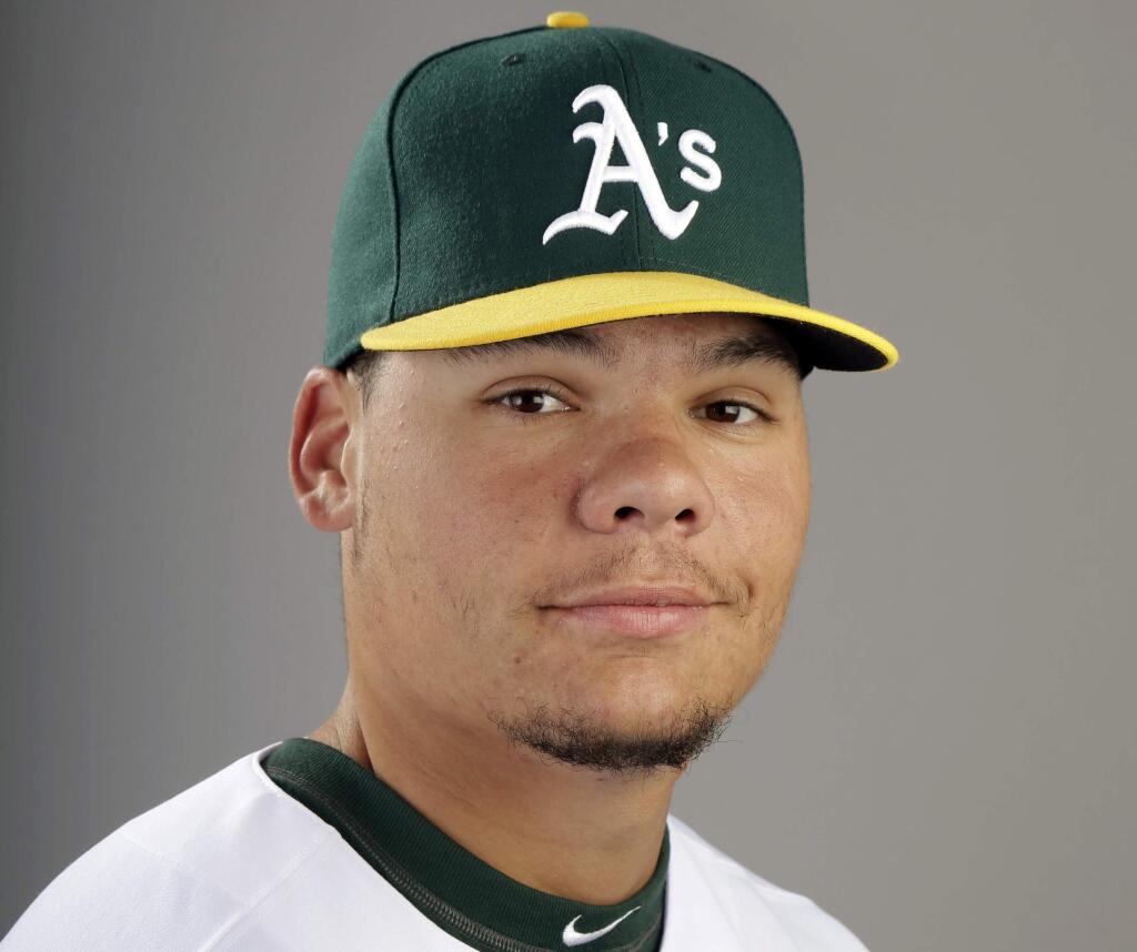 FILE - This 2014 file photo shows Oakland Athletics catcher Bruce Maxwell. Maxwell was arrested Saturday, Oct. 28, 2017, in Scottsdale, Ariz., after a female food delivery person alleged he pointed a gun at her. (AP Photo/ Gregory Bull, File)