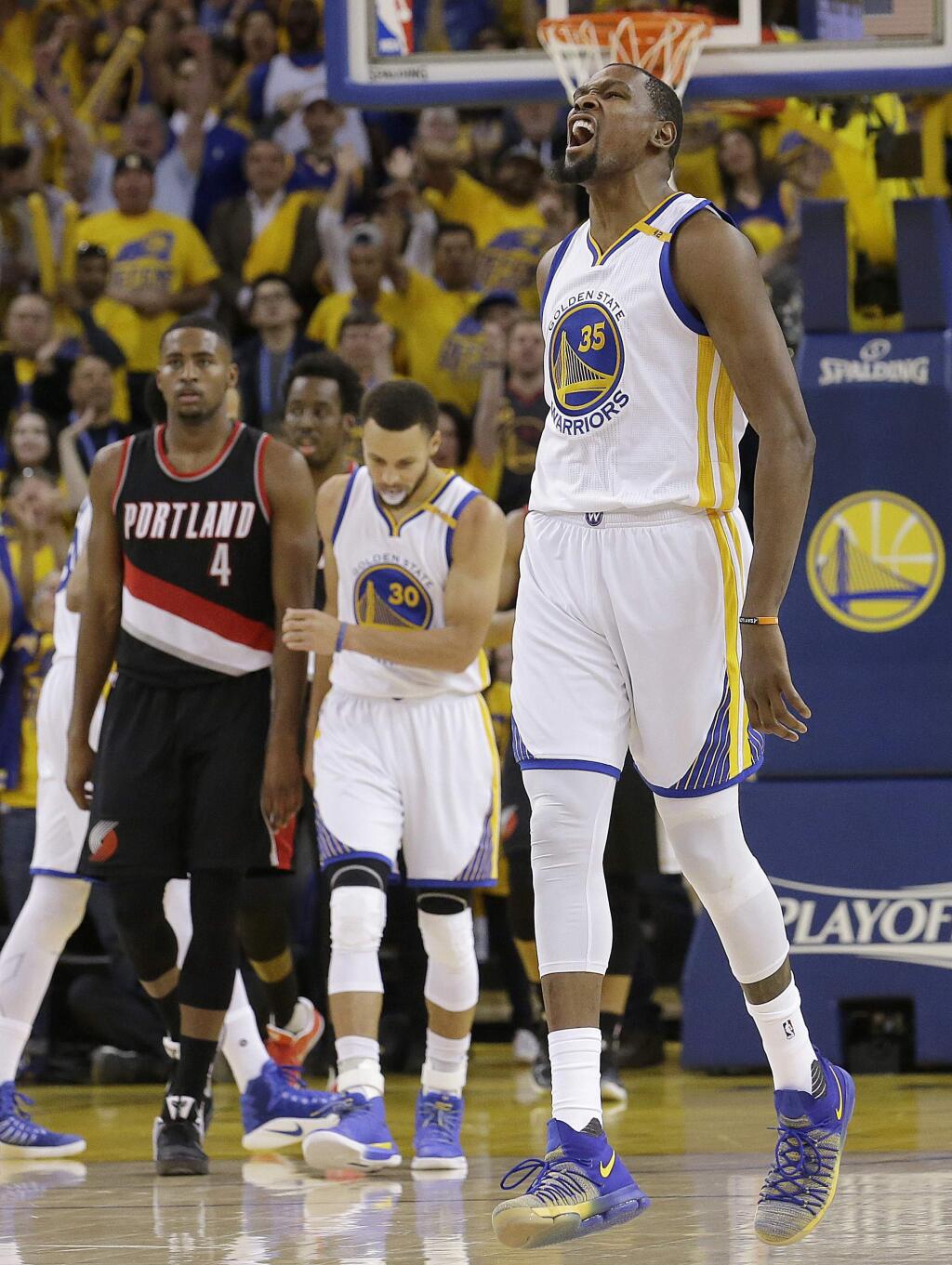 Golden State Warriors forward Kevin Durant (35) reacts after scoring against the Portland Trail Blazers during the second half of Game 1 of a first-round NBA basketball playoff series in Oakland, Calif., Sunday, April 16, 2017. The Warriors won 121-109. (AP Photo/Jeff Chiu)