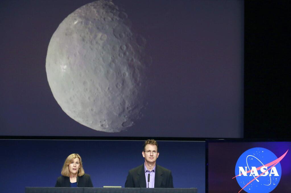 Robert Mase, right, project manager for the Dawn mission at Nasa's Jet Propulsion Laboratory, speaks at news conference, with Carol Raymond, deputy project scientist at JPL, left, at JPL in Pasadena on Monday, March 2, 2015. NASA's Dawn spacecraft is scheduled to slip into orbit around the dwarf planet Ceres on Friday, the last stop in a nearly eight-year journey. (AP Photo/Nick Ut)