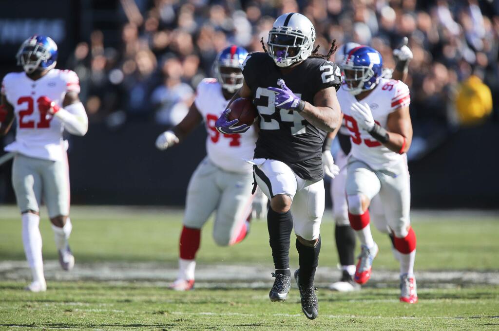 Oakland Raiders running back Marshawn Lynch runs for a 51-yard touchdown against the New York Giants during the first quarter of their game in Oakland on Sunday, Dec. 3, 2017. (Christopher Chung / The Press Democrat)