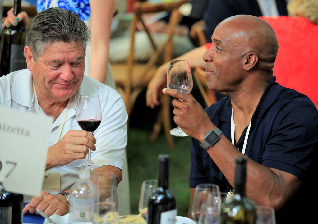 Barry Bonds (right) and Fred Biagi toast as the Auction heats up at the Auction Napa Valley, Saturday June 2nd, 2018 at Meadowood Napa Valley in Saint Helena California. (Photo Will Bucquoy / For the Press Democrat).