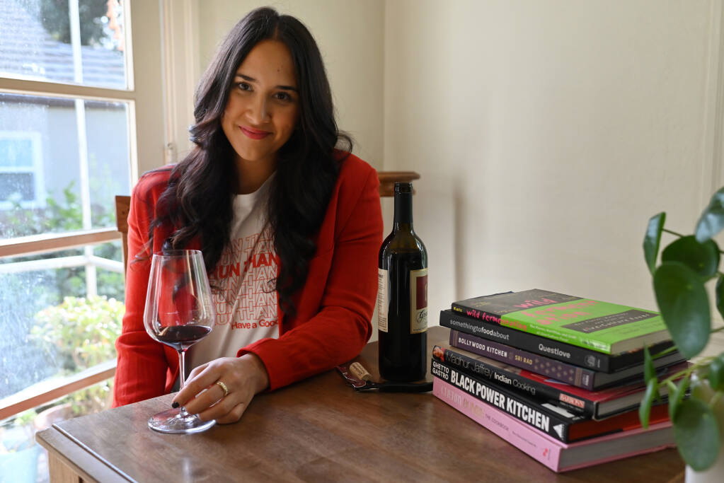 Maryam Ahmed a creative entrepreneur in the food and wine industry with a focus on diversity and sustainability with a few of her favorite cookbooks at her home in Napa, Calif. on Sunday, Oct. 30, 2022. (Erik Castro / For The Press Democrat)