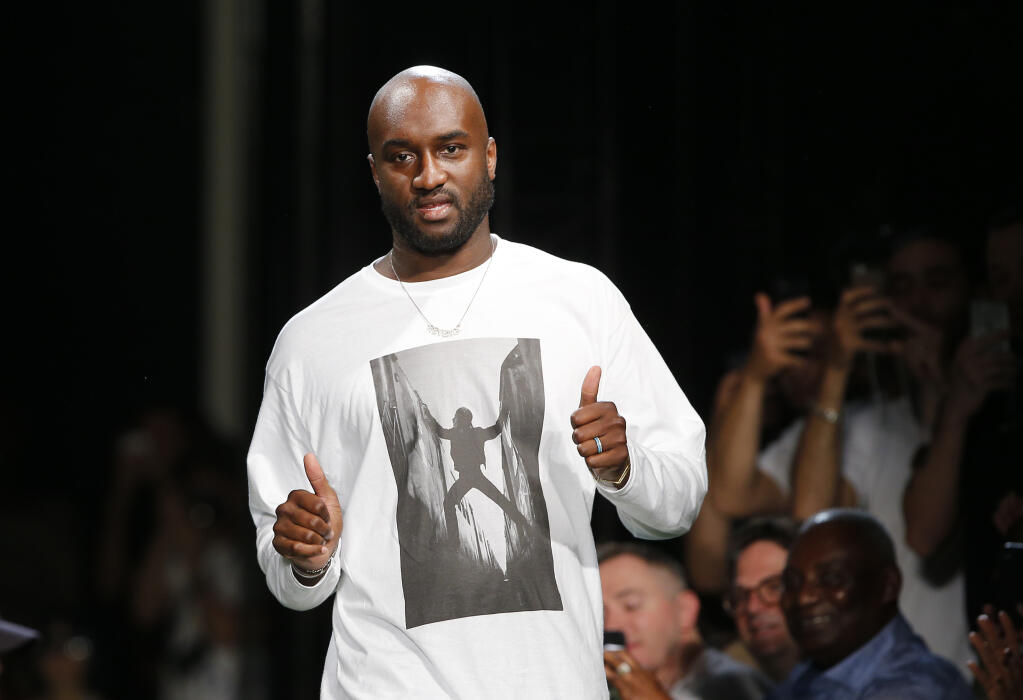 FILE -Fashion designer Virgil Abloh gives a thumbs up after the presentation of Off-White Men's Spring-Summer 2019 collection presented in Paris, Wednesday June 20, 2018. Abloh, a leading fashion executive hailed as the Karl Lagerfeld of his generation, has died after a private battle with cancer. He was 41. Abloh’s death was announced Sunday, Nov. 28, 2021 by LVMH Louis Vuitton and the Off White label, the brand he founded.  (AP Photo/Thibault Camus, File)