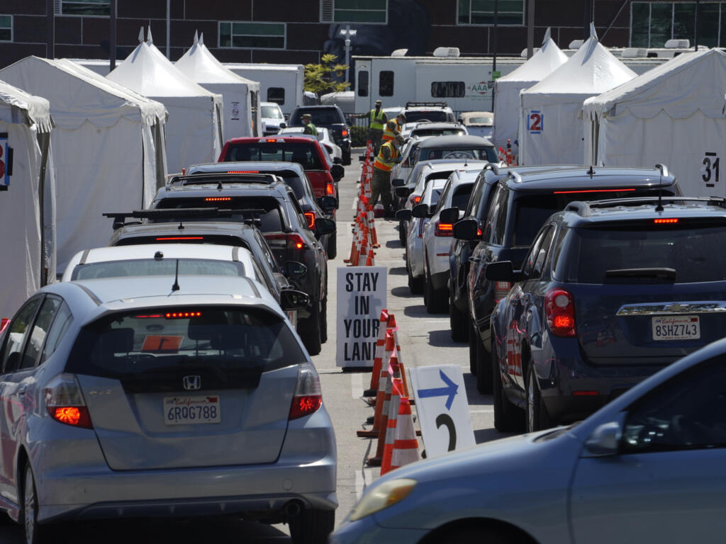 FILE - In this April 8, 2021, file photo,  motorists sit inside their vehicles as they wait their turn to be inoculated with a COVID-19 vaccine at the California State University, Los Angeles campus in Los Angeles. (AP Photo/Damian Dovarganes, File)