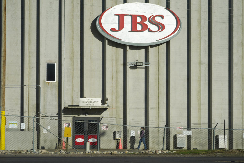 Hold For Release on Friday, Oct. 30, With Patty Nieberg Story slugged Virus Outbreak Lives Lost Meat Plant—A worker heads into the JBS meat packing plant Monday, Oct. 12, 2020, in Greeley, Colo. (AP Photo/David Zalubowski)