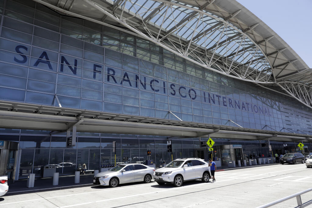 FILE - Vehicles wait outside the international terminal at San Francisco International Airport in San Francisco on July 11, 2017. Two airliners aborted landings at San Francisco International Airport on May 19, 2023, after pilots spotted a Southwest Airlines jet taxiing across runways on which the other planes had been cleared to land. The Federal Aviation Administration said Thursday, May 25, that it reviewed the matter and determined that appropriate steps were taken to ensure safety. (AP Photo/Marcio Jose Sanchez, File)