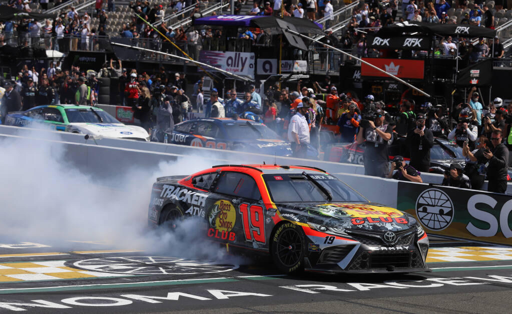 Martin Truex Jr (19) spins out in celebration after winning the Toyota/Save Mart 350 NASCAR Cup Series auto race at Sonoma Raceway, Sunday, June 11, 2023 in Sonoma. (Darryl Bush / For The Press Democrat)