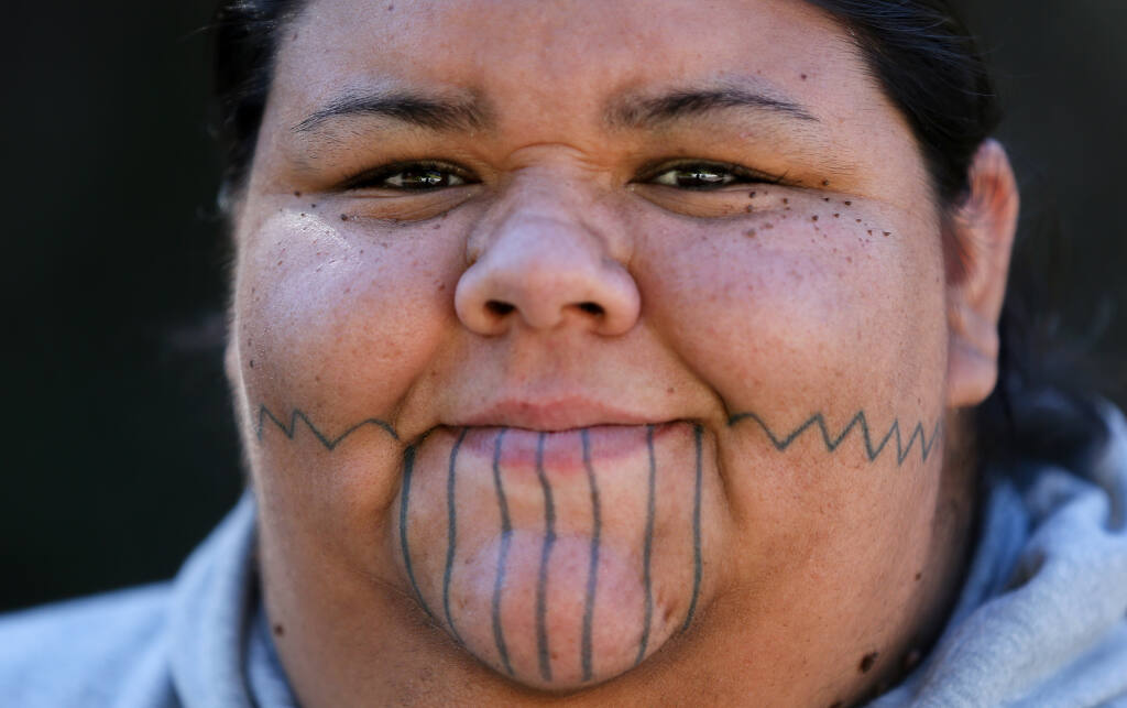 Rose Hammock is the co-leader of The Pomo Project. Hammock also makes herself available to schools and groups as a cultural resource by giving presentations on Native American History.  Her facial tattoos represent symbols from her Pomo culture.  (Christopher Chung/The Press Democrat file)