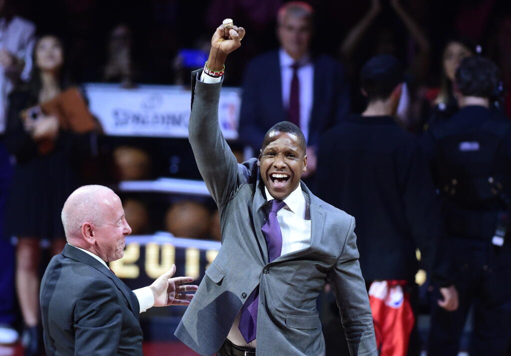 FILE - Toronto Raptors president Masai Ujiri receives his 2019 NBA basketball championship ring from Larry Tanenbaum, chairman of Maple Leaf Sports & Entertainment, before the Raptors played the New Orleans Pelicans in Toronto, Tuesday, Oct. 22, 2019.  A new video released by the attorneys of Ujiri appears to show an Alameda County sheriff's deputy initially shoved him twice leading to an altercation moments after his team had defeated the Golden State Warriors in last year's NBA championship. (Frank Gunn/The Canadian Press via AP,File)