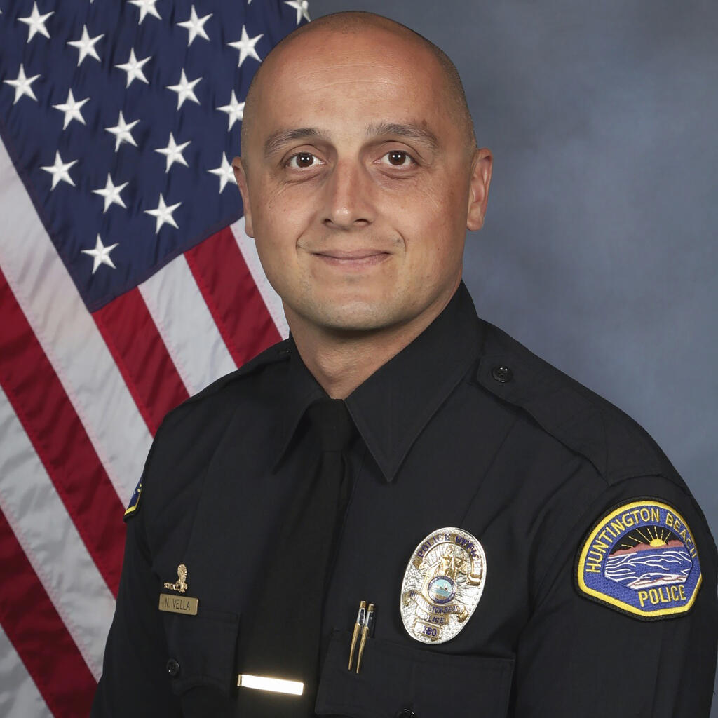 This photo provided by the Huntington Beach Police Department shows officer Nicholas Vella. Authorities say Vella was killed, Saturday, Feb. 19, 2022, and another officer was critically injured after a police helicopter crashed in water near California’s coast. Vella was a 14-year veteran with the department. (Huntington Beach Police Department via AP)