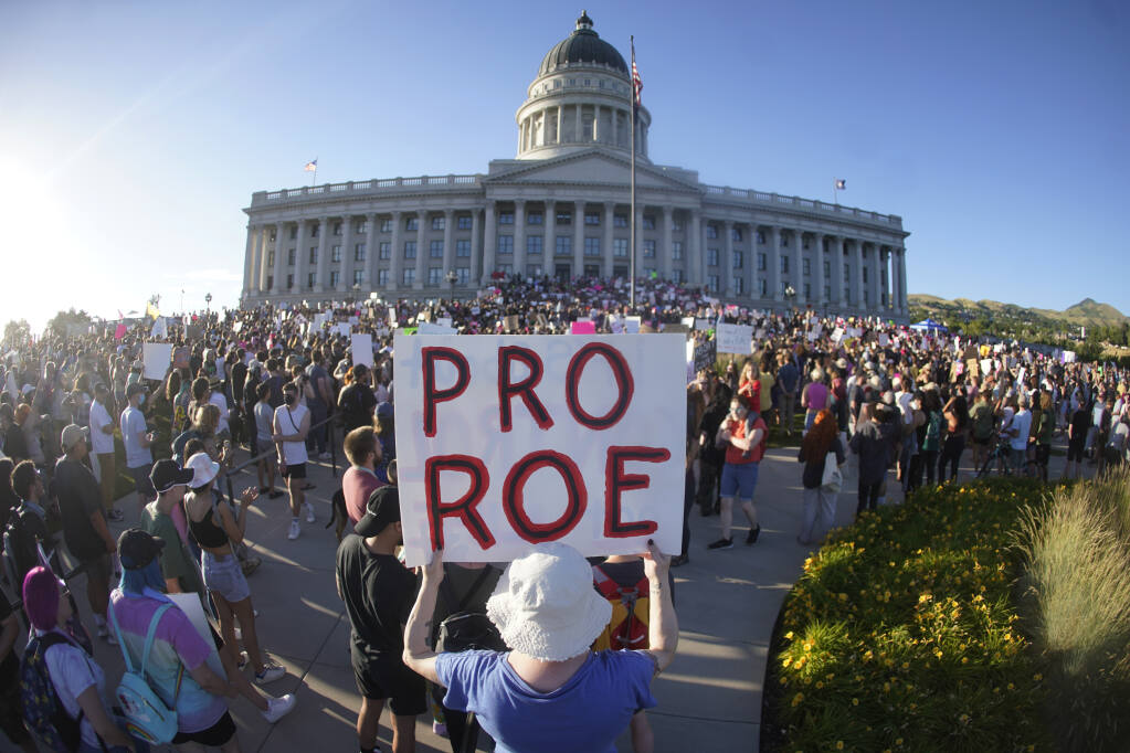 People attend an abortion-rights protest at the Utah State Capitol in Salt Lake City after the Supreme Court overturned Roe v. Wade, Friday, June 24, 2022. The U.S. Supreme Court's decision to end constitutional protections for abortion has cleared the way for states to impose bans and restrictions on abortion — and will set off a series of legal battles. (AP Photo/Rick Bowmer)