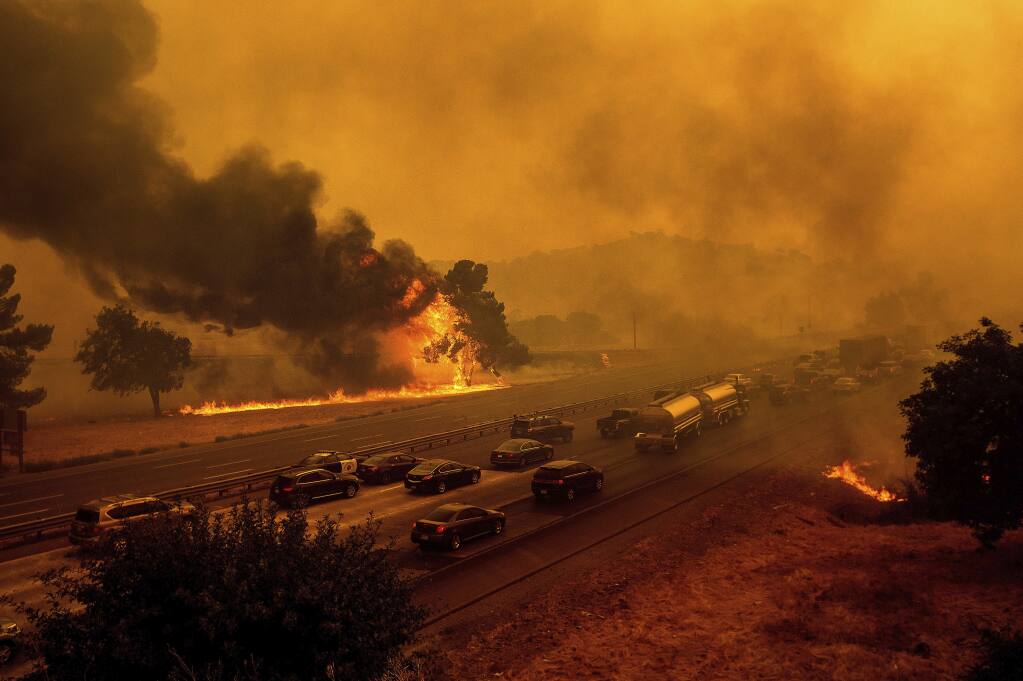 Flames from the LNU Lightning Complex fires jump Interstate 80 in Vacaville on Aug. 19. (NOAH BERGER / Associated Press)