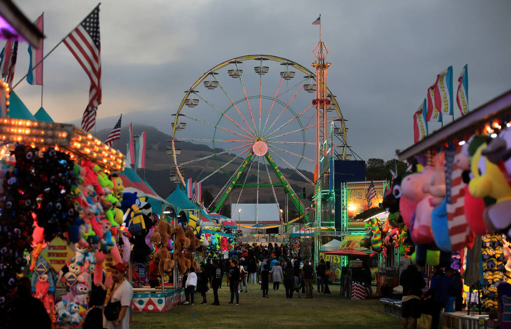 Fairgoers walk the Sonoma County Fair midway Thursday, Aug. 4, 2022, in Santa Rosa. (Kent Porter / The Press Democrat) 2022