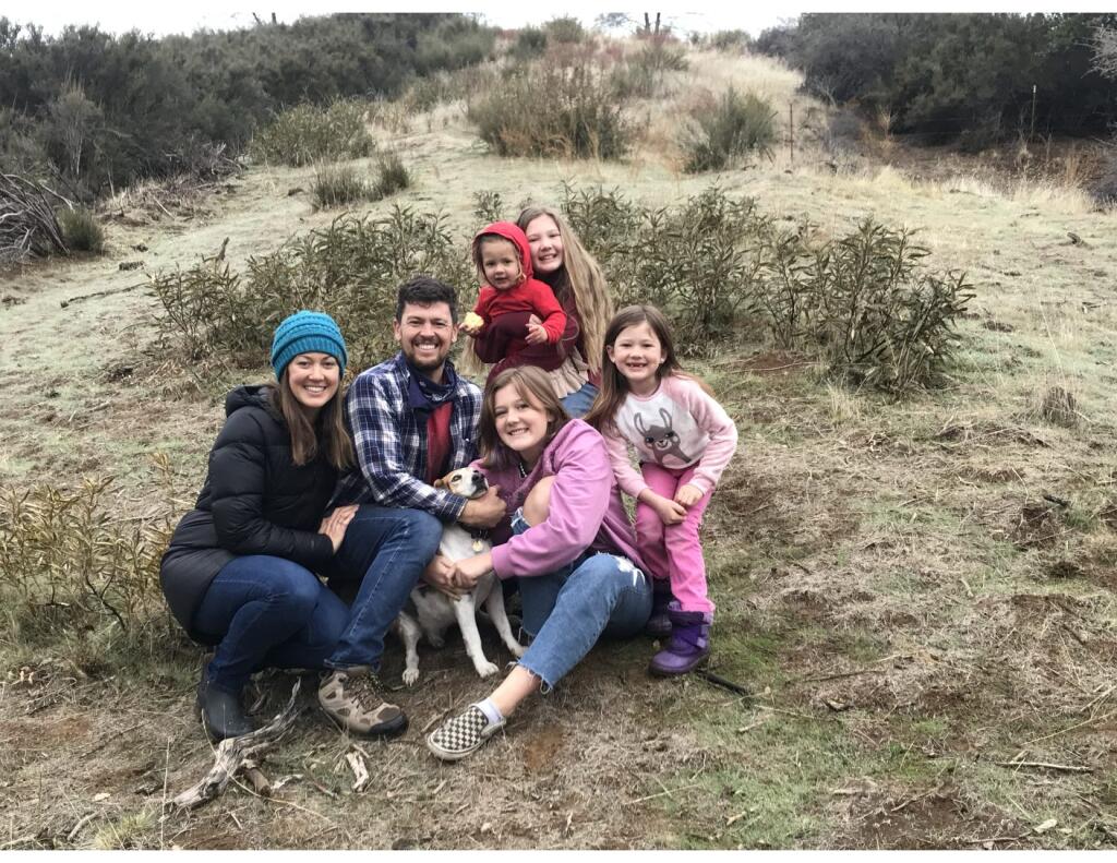 Brianne and Ben Holt and their girls, at the top, nearly 2-year-old Maliya and  Mackenzie,14; and lower, Madison, 10, and Maebel, 6. The dog is Phinn. (Holt family)