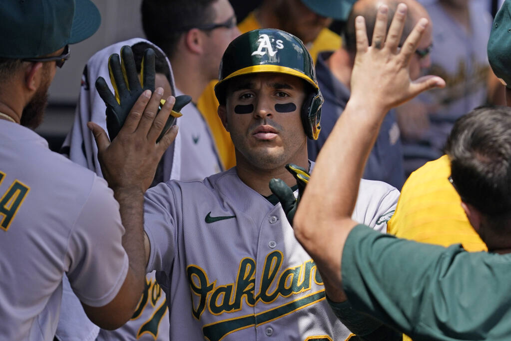 Oakland Athletics' Ramon Laureano celebrates with teammates after hitting a solo home run during the second inning of a baseball game against the Chicago White Sox in Chicago, Sunday, July 31, 2022. (AP Photo/Nam Y. Huh)