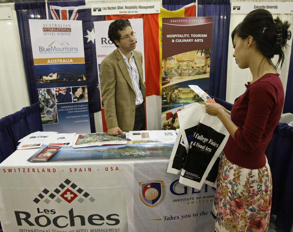 The days of the traditional college fair are gone - for now. (AP Photo/Damian Dovarganes)