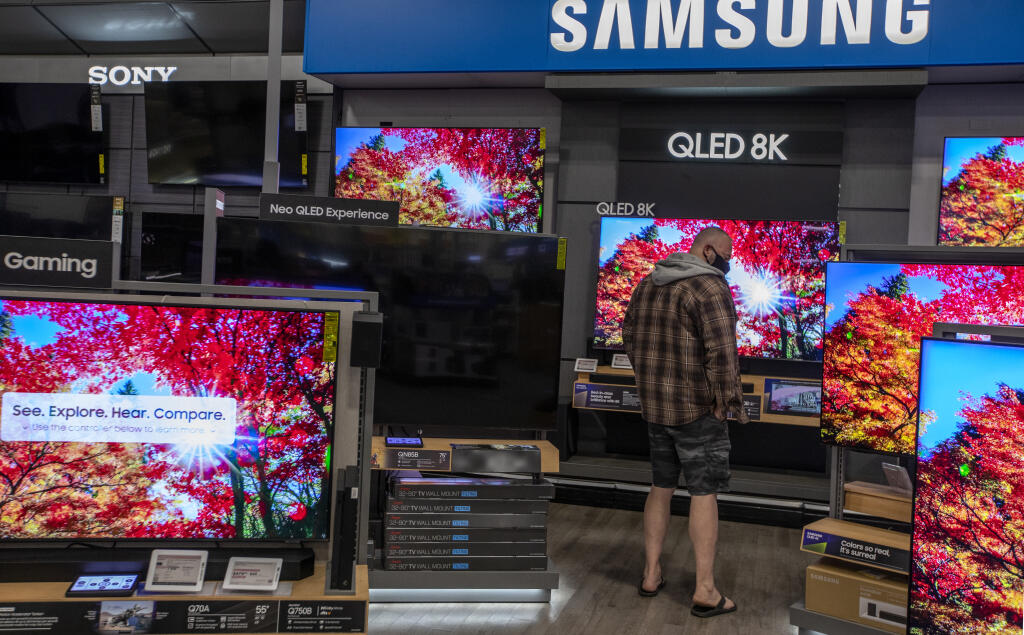 It’s 5:37 a.m. on Black Friday in Santa Rosa as a shopper at Best Buy checks the specs on different televisions on sale Friday Nov. 25, 2022. Opening attendance at 5 a.m. was sparse in comparison to years past with about 30 people waiting for the store to open. (Chad Surmick / The Press Democrat)