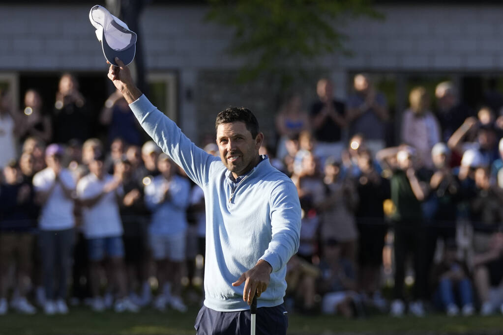 Charles Schwartzel of South Africa celebrates on the 18th green after winning the inaugural LIV Golf Invitational at the Centurion Club in St Albans, England, Saturday, June 11, 2022. (AP Photo/Alastair Grant)