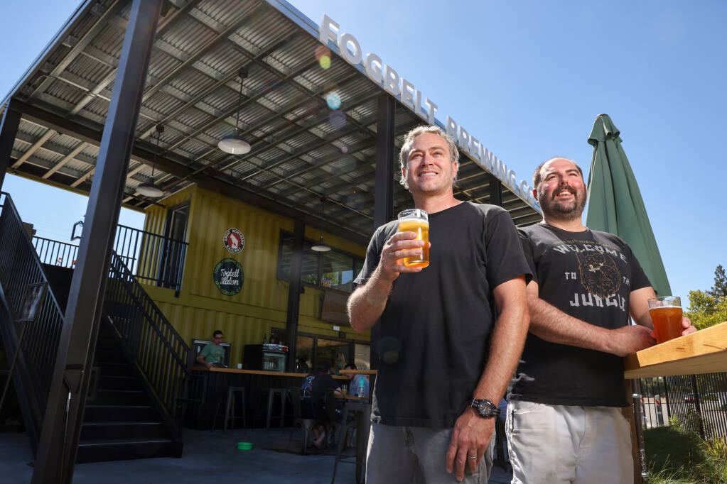 Fogbelt Brewing Company co-owners Paul Hawley, left, and Remy Martin at their new Fogbelt Station beer garden Friday, Aug. 12, 2022, in Healdsburg.  (Christopher Chung/The Press Democrat)