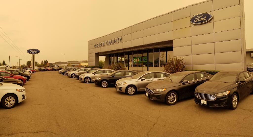 Marin County Ford, seen under the sepia-toned sky of wildfire smoke in recent weeks, believes the latest automakers incentives and fear of COVID-19 are prompting many to buy both used and new vehicles in great numbers. (courtesy photo)