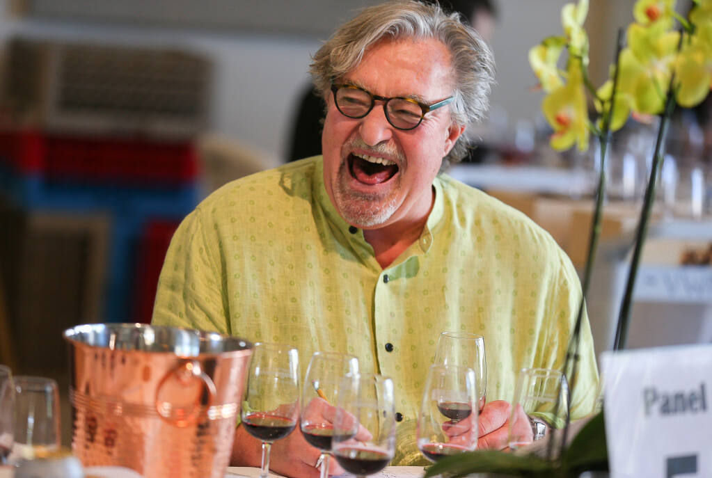 Kerry Damskey, wine consultant and winemaker, laughs while discussing a wine during the North Coast Wine Challenge in Santa Rosa on Tuesday, April 5, 2022.  (Christopher Chung/ The Press Democrat)