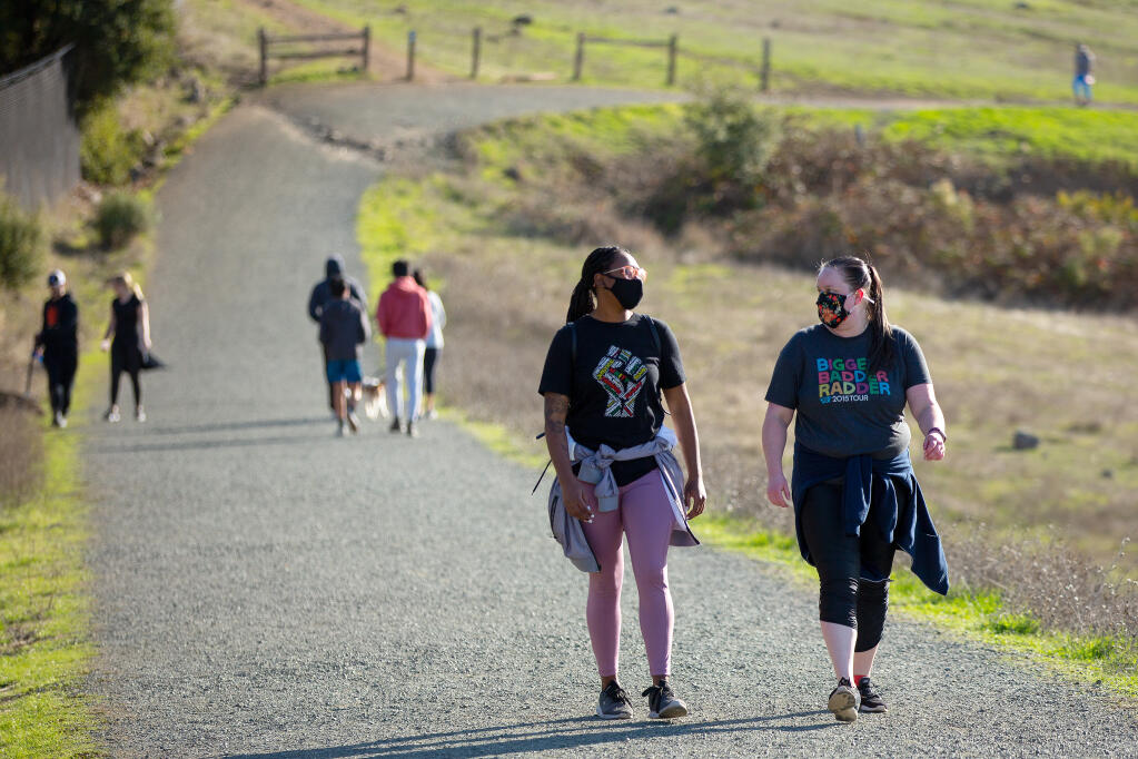 Kitara McCray, left, and Kelsey Bjugstad chat while walking along the Western Route trail at Taylor Mountain Regional Park in Santa Rosa on Wednesday, Dec. 30, 2020. (Alvin A.H. Jornada / The Press Democrat)