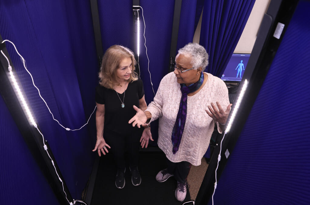 Software Tailoring owner Giovonnae Anderson, right,  describes how the imaging process will work to customer  Bonnie Van Anda, prior to a complete head to toe, 360 degree, three-dimensional scan of her body, Thursday, March 8, 2023, in Santa Rosa.  The scanning process has to be done with the person unclothed. (Kent Porter / The Press Democrat)