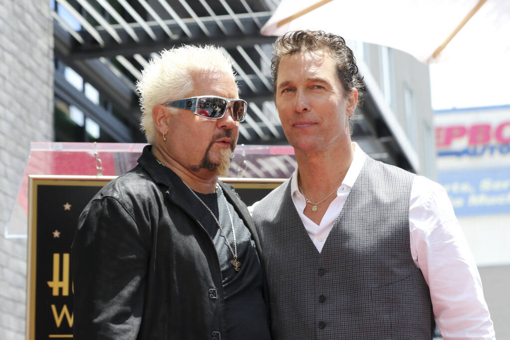 Guy Fieri, left, and Matthew McConaughey speak following a ceremony honoring Guy Fieri with a star at the Hollywood Walk of Fame on Wednesday, May 22, 2019, in Los Angeles. (Photo by Willy Sanjuan/Invision/AP)