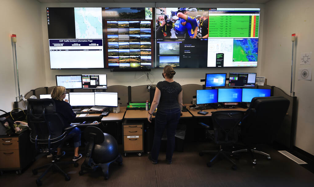 Redcom's Kendell Lynn, left, and Monica Vanoni monitor the Wildfire Alert cameras, Tuesday, June 29, 2021.  Redcom is located in the Sonoma County Sheriff's Department headquarters in Santa Rosa.  (Kent Porter / The Press Democrat) 2021