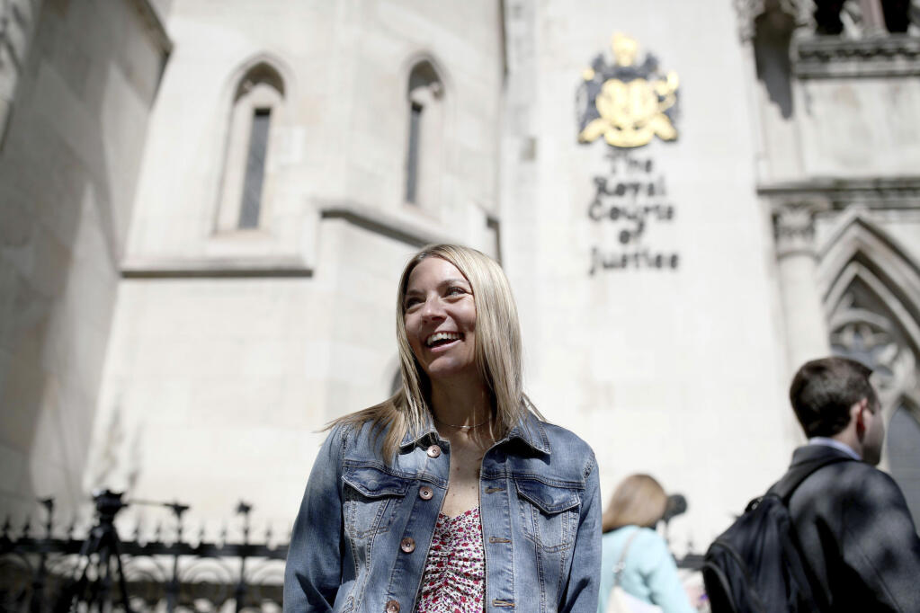 Emma Jones, the daughter of now deceased postmaster Julian Wilson, outside the Royal Courts of Justice, London, after her father's conviction was overturned by the Court of Appeal, Friday, April 23, 2021. A British appeals court has overturned the convictions of 39 postmasters and postmistresses who were accused of theft, fraud and false accounting following the installation of a new computer system in local branches. Announcing the Court of Appeal ruling on Friday, a judge said Britain’s postal service “knew there were serious issues about the reliability” of the Horizon computer system and had a “clear duty to investigate” its defects. (Yui Mok/PA via AP)