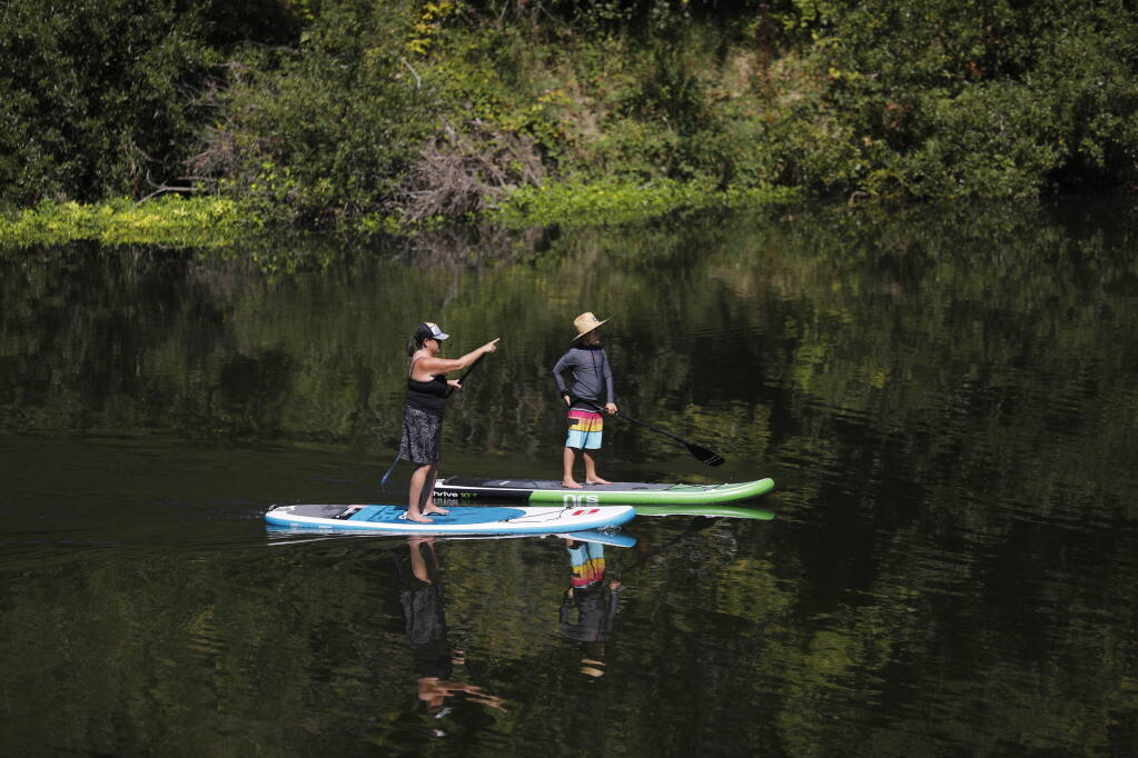 Paddle boarders float on the Russian River past the new boat ramp at Guerneville River Park in Guerneville, Calif. on Sunday, August 14, 2022. (Beth Schlanker/The Press Democrat)