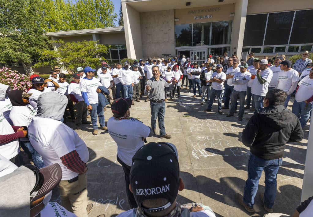 Raul Calvo speaks to farmworkers wearing matching “NBJwJ does NOT Speak for Me” t-shirts outside of the  Sonoma County Supervisors meeting, Monday, May 3, 2022.   (John Burgess/The Press Democrat)