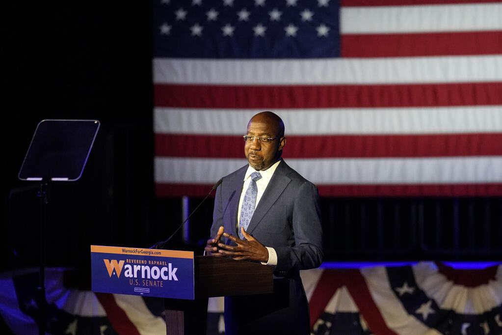 Democratic nominee for U.S Senate Sen. Raphael Warnock speaks during an election-night watch party Wednesday, Nov. 9, 2022 in Atlanta. (AP Photo/John Bazemore)
