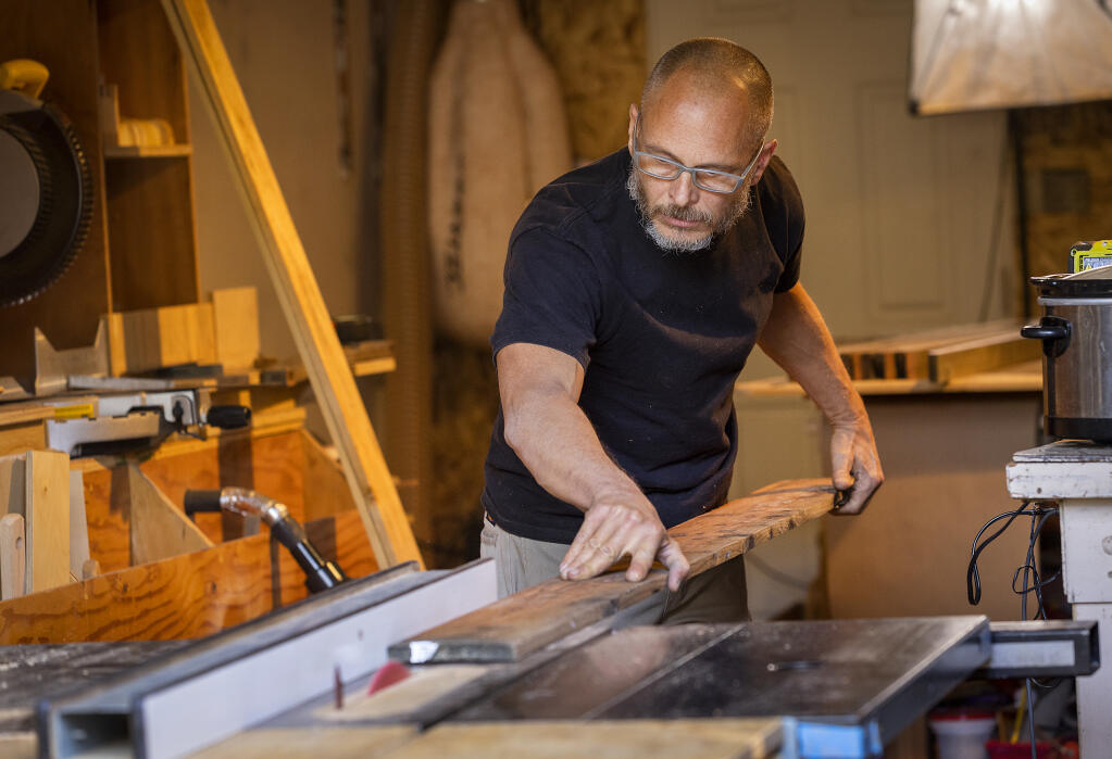 Wes Hardy left his job in the fitness industry after almost 30 years and has begun to learn the basics of woodworking in his Santa Rosa home garage, Wednesday, Oct. 12, 2022. (John Burgess/The Press Democrat)