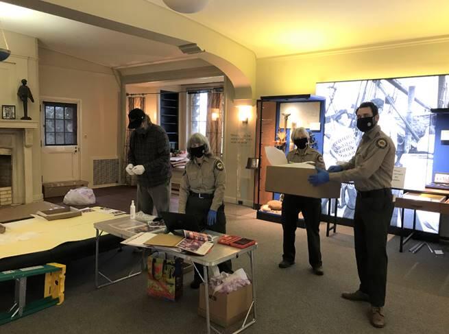 Noah Stewart, Carol Dodge, Kathleen Wolcott and Ronnie Cline work together to reinstall the artifacts and displays at the Jack London State Historic Park. Photo provided.