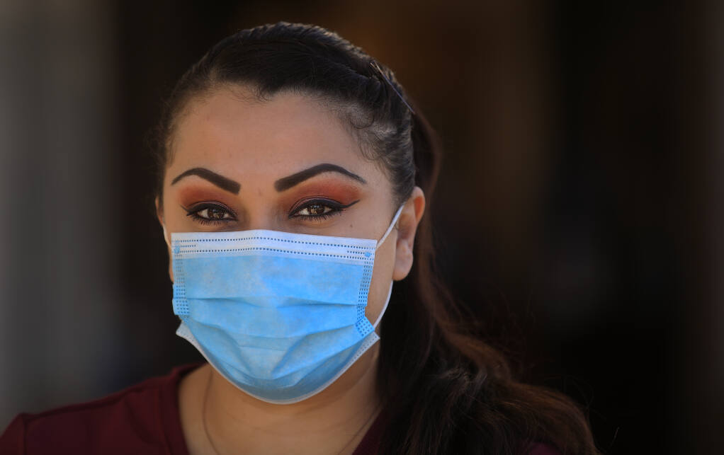 Carmen Amavisca, a housekeeper at Santa Rosa Memorial Hospital, Friday, March 19, 2021, received her first dose of Pfizer-BioNTech vaccine on Dec. 22, but at the same time contracted COVID.  (Kent Porter / The Press Democrat) 2021