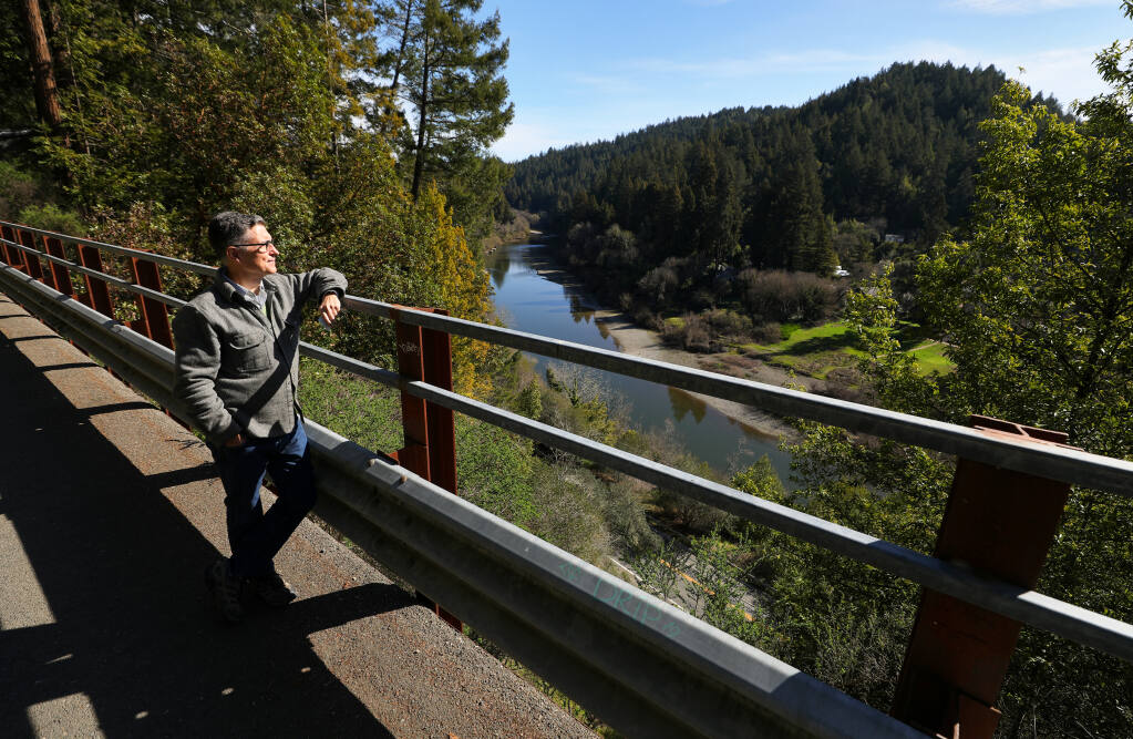 John Dunlap is opposed to a 224-acre logging plan for the area above Neeley Road, near Vacation Beach, visible on the right of the Russian River, between Guerneville and Monte Rio.  Local opponents to the plan are concerned about erosion, landslides, sediment, and impacts to wildlife, wildfire and the scenic corridor. (Christopher Chung/ The Press Democrat)