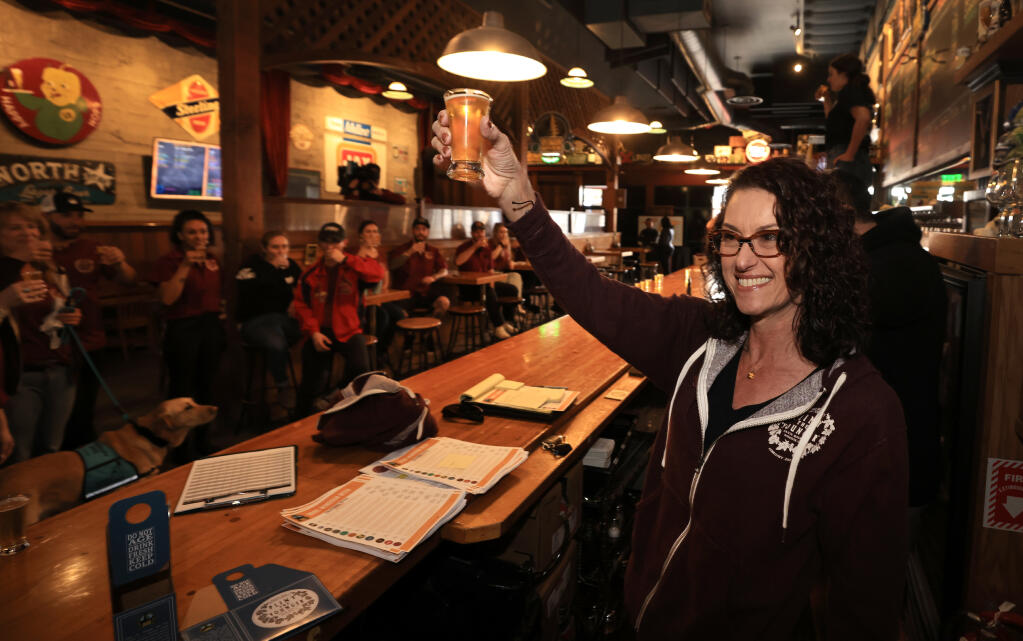 Natalie Cilurzo, owner of the Russian River Brewing Co. in Santa Rosa, toasts to the release of the long-delayed Pliny the Younger with her employees, Friday, March 25, 2022, before opening their doors to the public. (Kent Porter / The Press Democrat)