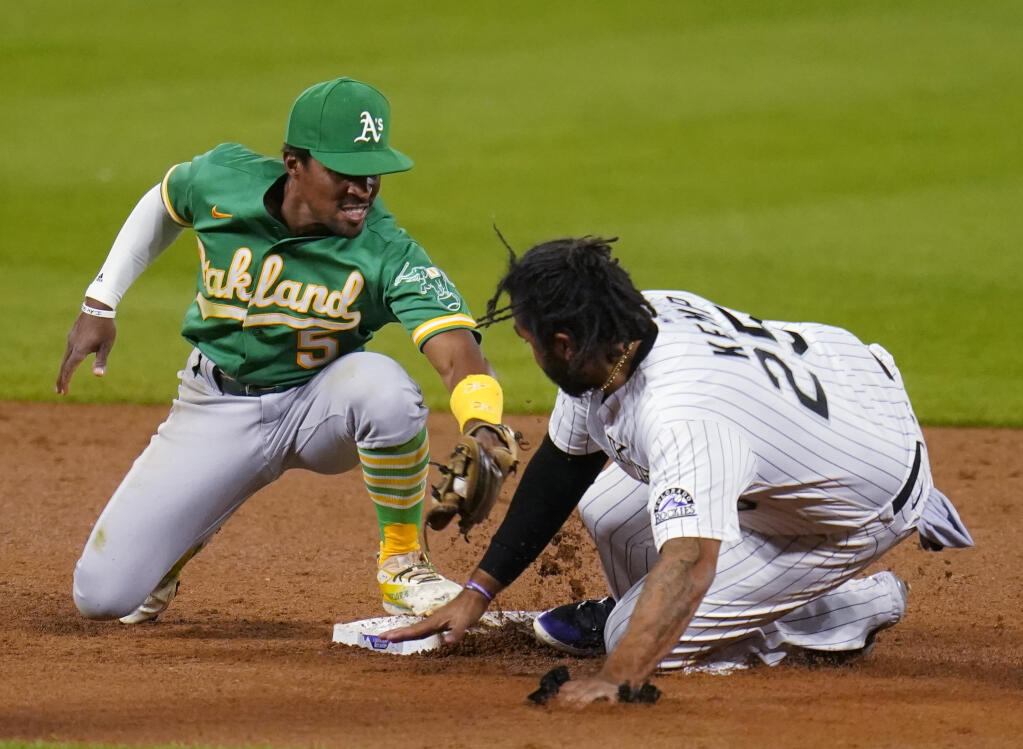The Oakland Athletics’ Tony Kemp is late with the tag on the Colorado Rockies’ Matt Kemp during the sixth inning, Tuesday Sept. 15, 2020, in Denver. Kemp advanced on a sacrifice fly by Josh Fuentes. (Jack Dempsey / ASSOCIATED PRESS)